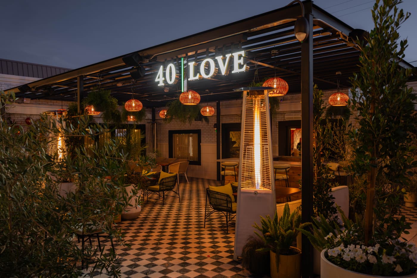 40 Love patio at dusk, with the 40 · Love sign lit